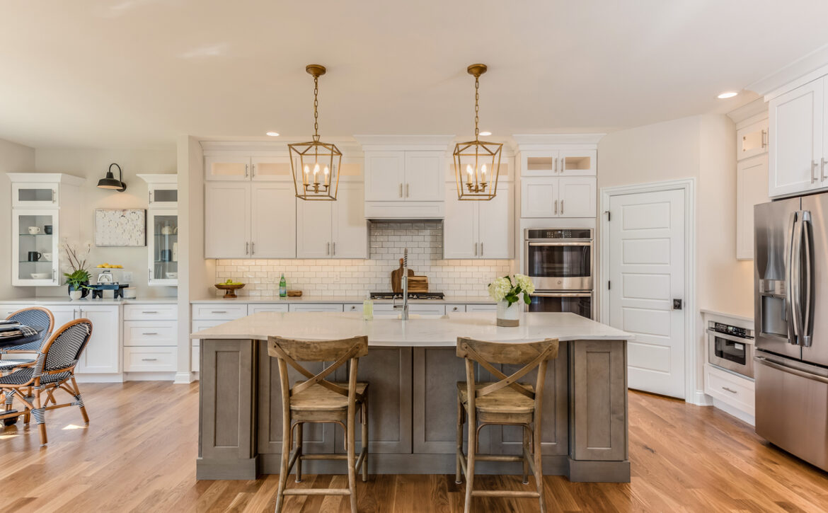 Two pendant lights hang over kitchen island