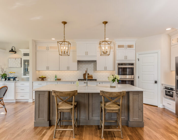 Two pendant lights hang over kitchen island