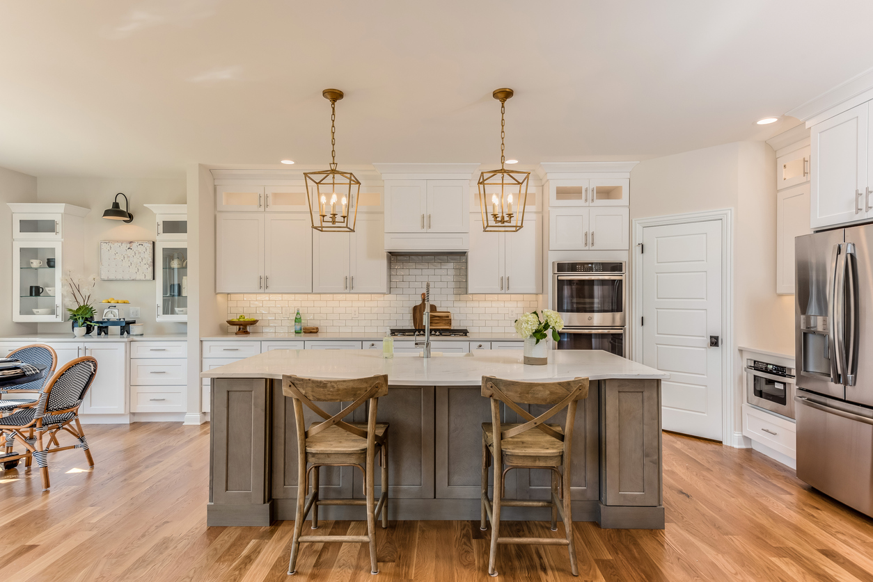 Two pendant lights hang over kitchen island